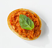 Crostini with tomato pesto and basil leaf