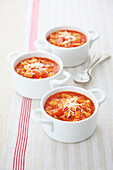 Mini tomato and bean pasta soup with grated cheese
