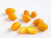 Eight small yellow kumquats