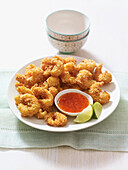Spicy coconut prawns with chilli dip and limes