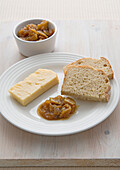 Green tomato chutney, bread and cheese on plate