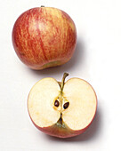 Half of an apple showing flesh, core, pips and stalk