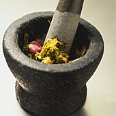 Pestle and mortar with curry ingredients