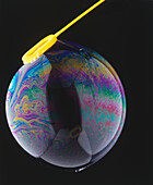 Colourful pattern formed on surface of soap bubble