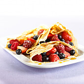 Pancakes filled with strawberries, raspberries and blueberries