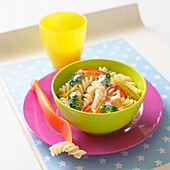 Pasta and vegetable in cheese sauce in plastic bowl