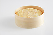 Whole round of Soumaintrain cow's milk cheese in wooden box