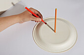 Creating a homemade sundial with a pencil and a paper plate