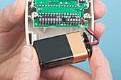 Inserting battery into a passive infrared sensor