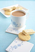 Cup of milky tea, butter biscuits and shortbread