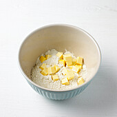 Chunks of butter and flour in mixing bowl