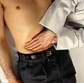 Doctor palpating abdomen