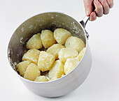 Returning pre-cooked and drained potatoes to the pan