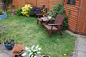 Small garden with shed, turfed lawn with garden chairs
