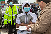 Worker checking IDs as water filters are distributed, USA