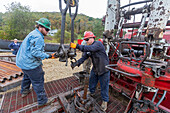 Workers plugging an abandoned oil well