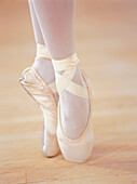 Legs of a ballerina standing on pointes