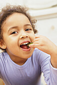 Girl smiling while eating