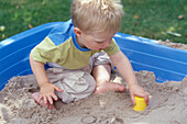 Boy playing in a sand pit