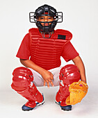Boy dressed in baseball protective clothing