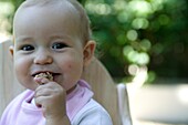 Baby girl eating cookie