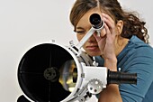 Woman looking through eyepiece of finderscope