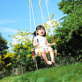 Smiling girl on a swing