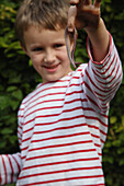 Boy holding earthworm
