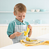Boy peeling a banana in kitchen