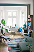 Various seating and Swiss cheese plant in living room with bay window