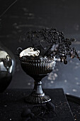 Dark still life with antique bowl and dried plants