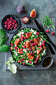 Rocket salad with figs, raspberries, and feta cheese