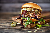 Pulled pork sandwich with red cabbage, onions, and cheese