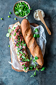 Roast beef sandwich with cream cheese and green peas