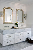 Double sink marble vanity in a bright bathroom