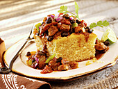 Chili with black beans and onions servved on cornbread