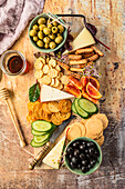 Cheese platter with crackers and olives