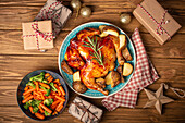 Festive Christmas dinner with roasted whole chicken and vegetables top