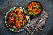 Delicious roasted whole chicken with golden crispy skin and steamed vegetables