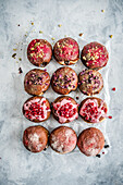 Donuts with rose petals and pomegranate seeds