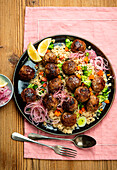 Lamb balls on couscous with vegetables