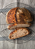 Wheat sourdough bread, sliced and placed on a cooling rack