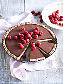 Unbaked chocolate cake with raspberries