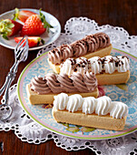 Sponge cakes with chocolate and cream toppings