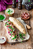 Sandwich with prosciutto and green peas
