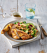 Chicken breast served with broccoli salad with avocado and chickpeas