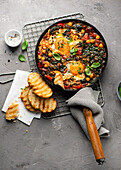 Shakshuka with chickpeas and spinach served with toasted bread