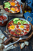 Fried eggs with chorizo, tomatoes and avocado