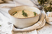Cauliflower soup topped with fresh thyme