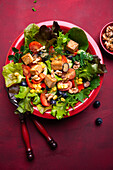 Salad with bell pepper, corn, walnuts, blueberries, and tofu